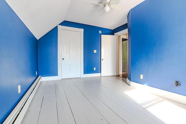 24 High St, Livermore Falls, ME 04254 - unfurnished bedroom featuring a baseboard heating unit, lofted ceiling, wood finished floors, a closet, and ceiling fan