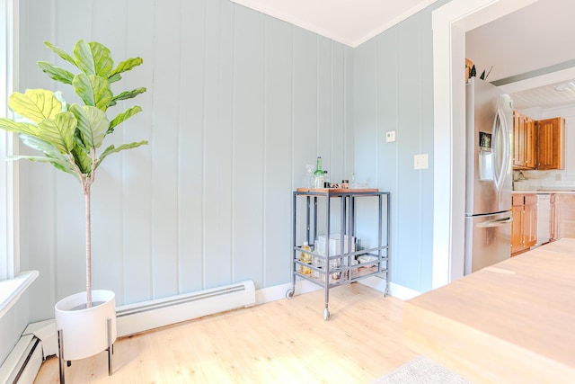 24 High St, Livermore Falls, ME 04254 - corridor featuring baseboard heating, wood finished floors, ornamental molding, and a decorative wall