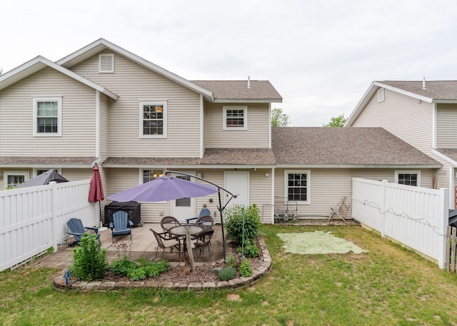 38 Guadalcanal St Unit 38, Brunswick, ME 04011 - back of property with a shingled roof, a patio, and a fenced backyard