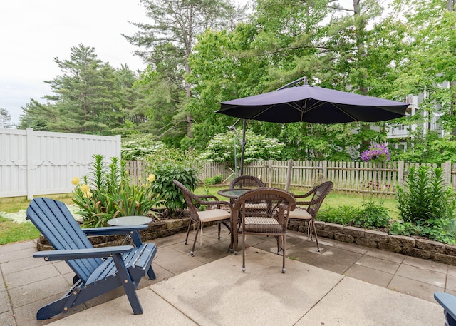 38 Guadalcanal St Unit 38, Brunswick, ME 04011 - fenced backyard with a patio area and outdoor dining space