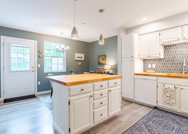 38 Guadalcanal St Unit 38, Brunswick, ME 04011 - kitchen with white dishwasher, wooden counters, light wood-style floors, backsplash, and a center island