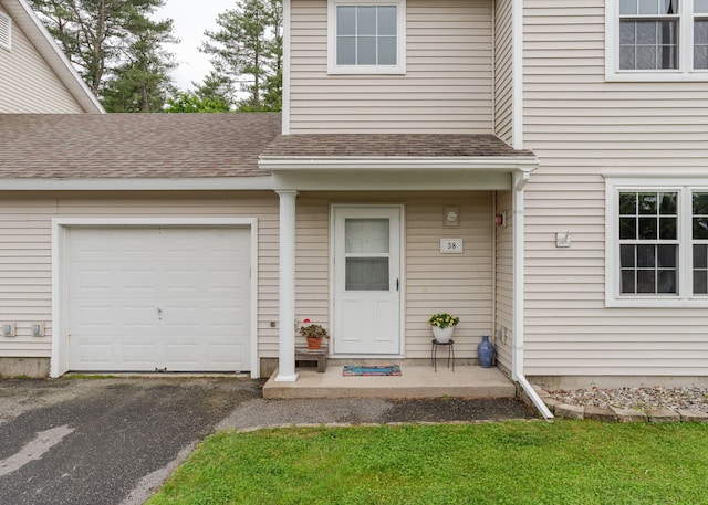 38 Guadalcanal St Unit 38, Brunswick, ME 04011 - property entrance with a shingled roof, asphalt driveway, and a garage
