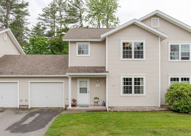 38 Guadalcanal St Unit 38, Brunswick, ME 04011 - view of front of home featuring a garage, asphalt driveway, a shingled roof, and a front yard