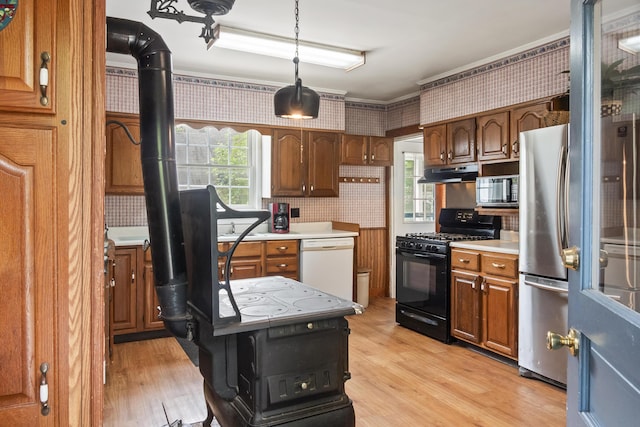 785 W Main St, Waldoboro, ME 04572 - kitchen featuring black appliances, under cabinet range hood, light countertops, wallpapered walls, and light wood-style flooring