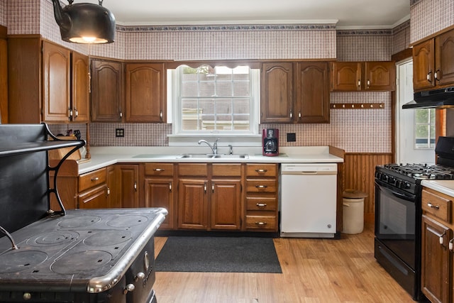 785 W Main St, Waldoboro, ME 04572 - kitchen featuring dishwasher, black gas stove, wallpapered walls, light wood finished floors, and light countertops