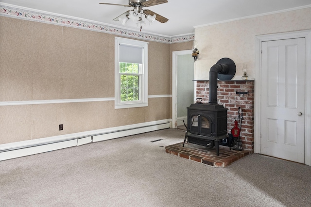 785 W Main St, Waldoboro, ME 04572 - unfurnished living room with a wood stove, carpet flooring, a baseboard radiator, a ceiling fan, and ornamental molding