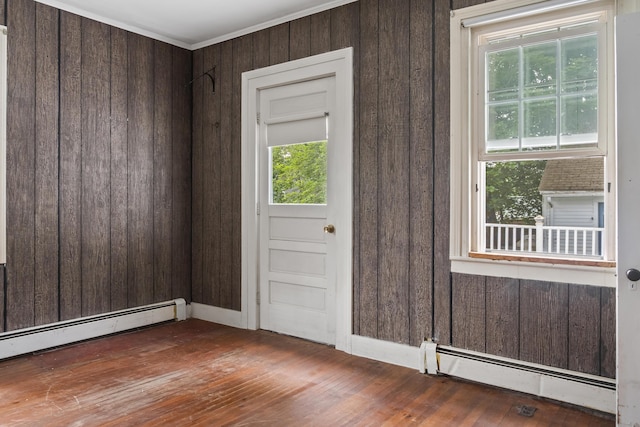 785 W Main St, Waldoboro, ME 04572 - entrance foyer with baseboard heating, healthy amount of natural light, hardwood / wood-style flooring, wood walls, and crown molding