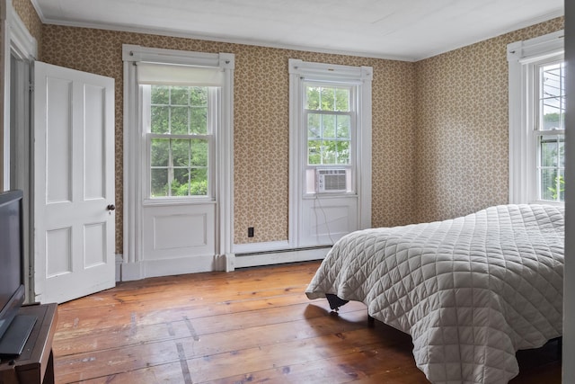 785 W Main St, Waldoboro, ME 04572 - bedroom featuring a baseboard heating unit, hardwood / wood-style floors, ornamental molding, wallpapered walls, and cooling unit