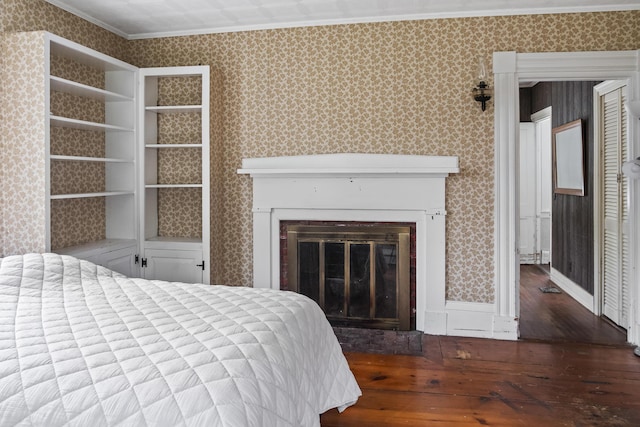 785 W Main St, Waldoboro, ME 04572 - bedroom featuring wood finished floors, ornamental molding, a glass covered fireplace, and wallpapered walls