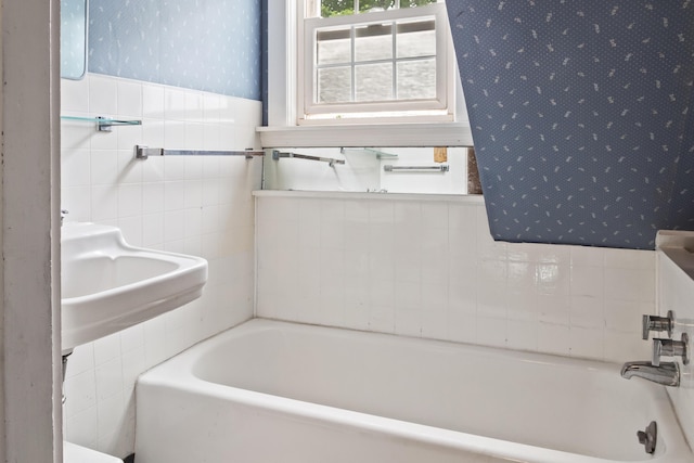 785 W Main St, Waldoboro, ME 04572 - full bath featuring tile walls, wallpapered walls, a bathtub, and wainscoting