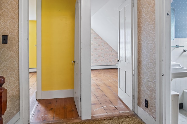 785 W Main St, Waldoboro, ME 04572 - hallway with wallpapered walls, wood-type flooring, and a baseboard heating unit