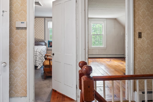 785 W Main St, Waldoboro, ME 04572 - hallway with wallpapered walls, a baseboard heating unit, wood-type flooring, and lofted ceiling