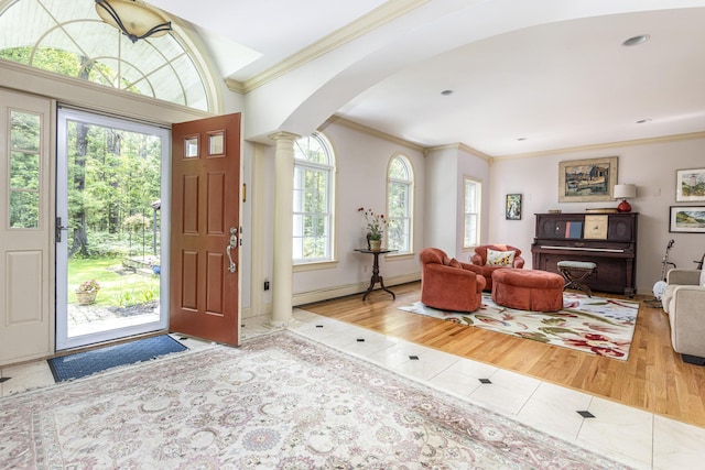 36 Acorn Ln, South Portland, ME 04106 - tiled foyer featuring ornate columns, arched walkways, crown molding, and baseboard heating
