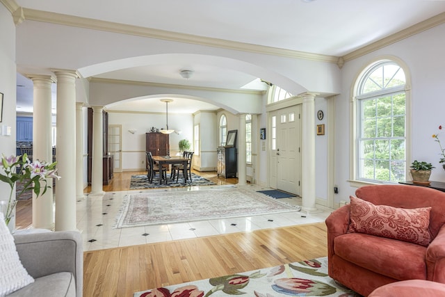 36 Acorn Ln, South Portland, ME 04106 - foyer entrance featuring arched walkways, decorative columns, ornamental molding, and light tile patterned floors