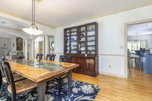 36 Acorn Ln, South Portland, ME 04106 - dining room featuring decorative columns, crown molding, and light wood-type flooring