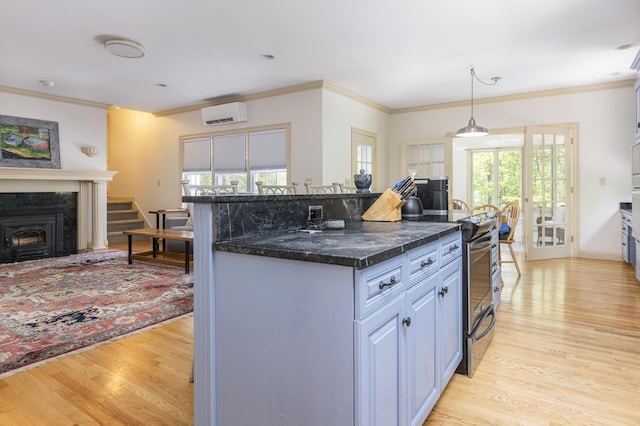 36 Acorn Ln, South Portland, ME 04106 - kitchen featuring stainless steel range with electric cooktop, light wood-style flooring, crown molding, a wall mounted AC, and a kitchen island