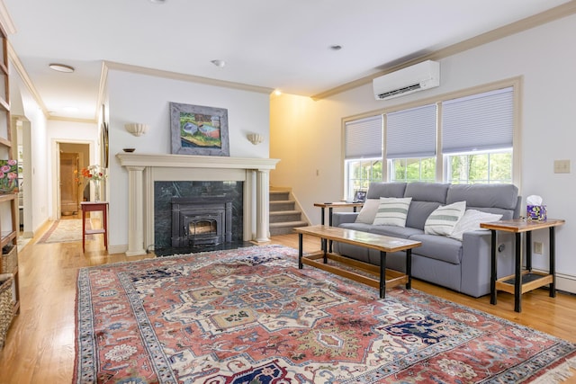 36 Acorn Ln, South Portland, ME 04106 - living room with an AC wall unit, ornamental molding, wood finished floors, a high end fireplace, and stairway