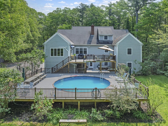 36 Acorn Ln, South Portland, ME 04106 - rear view of property with a deck, stairs, an outdoor pool, a chimney, and roof with shingles