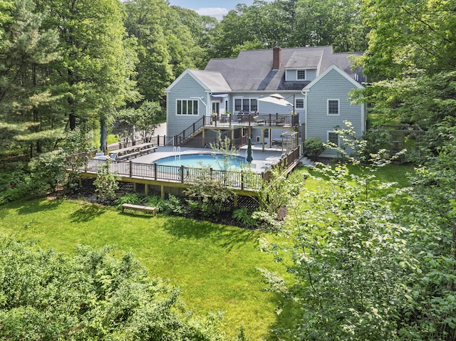 36 Acorn Ln, South Portland, ME 04106 - back of property with a deck, stairs, an outdoor pool, a chimney, and roof with shingles