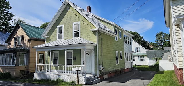 11 Gray St, Waterville, ME 04901 - view of front of property with covered porch, a standing seam roof, a chimney, and metal roof