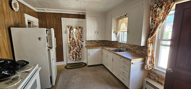 11 Gray St, Waterville, ME 04901 - kitchen featuring a baseboard heating unit, a sink, white cabinetry, light countertops, and crown molding