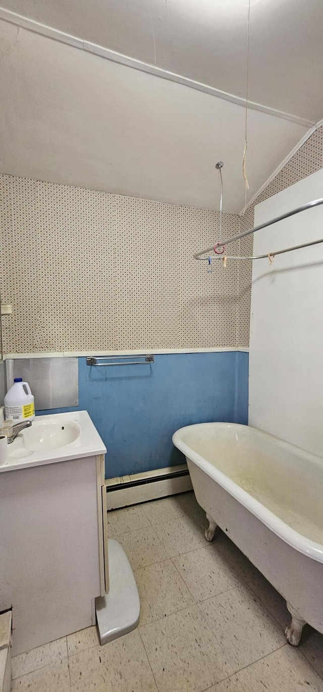 11 Gray St, Waterville, ME 04901 - bathroom with baseboard heating, a soaking tub, vanity, and tile patterned floors