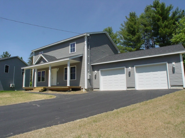 29 Deer Pond Ln, Bangor, ME 04401 - view of front of home with driveway, a garage, covered porch, and a front lawn