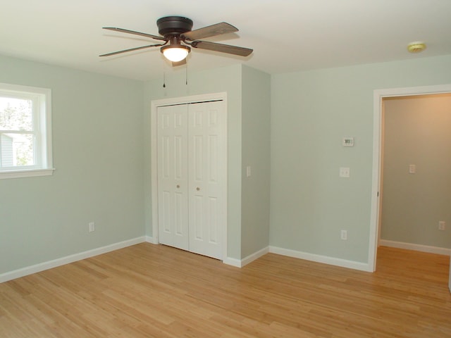 29 Deer Pond Ln, Bangor, ME 04401 - unfurnished bedroom with light wood-type flooring, a closet, baseboards, and a ceiling fan