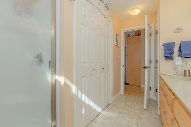 135 Lyle Hall Rd, Wilton, ME 04294 - full bathroom with a stall shower, vanity, tile patterned flooring, and baseboards