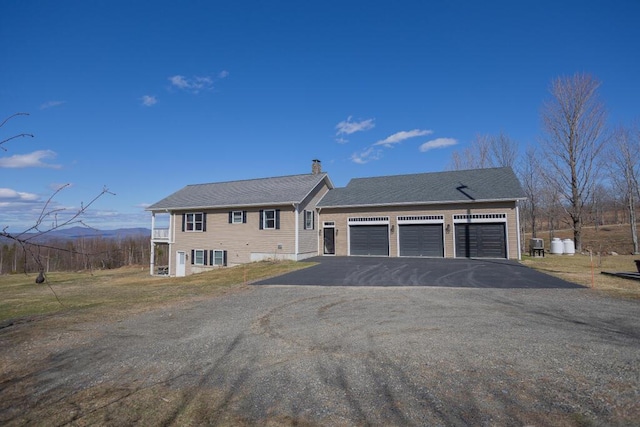 135 Lyle Hall Rd, Wilton, ME 04294 - view of front of property with a garage, a chimney, and driveway