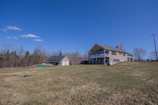 135 Lyle Hall Rd, Wilton, ME 04294 - view of grassy yard with a garage and an outbuilding