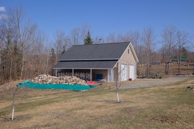 135 Lyle Hall Rd, Wilton, ME 04294 - view of side of property featuring a yard, a shingled roof, and a detached garage