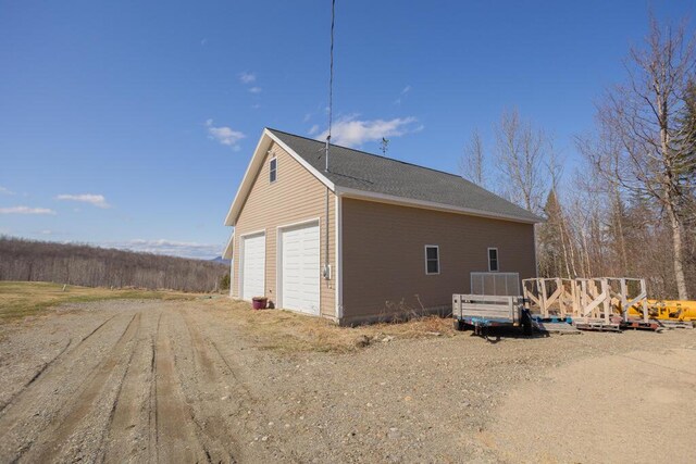 135 Lyle Hall Rd, Wilton, ME 04294 - view of side of home with a deck, a detached garage, and an outbuilding