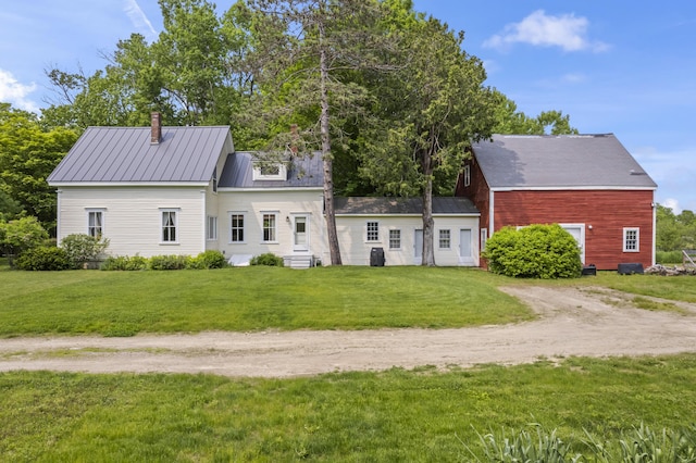 145 Pork Point Rd, Bowdoinham, ME 04008 - view of front of home with dirt driveway, a front yard, metal roof, and a chimney