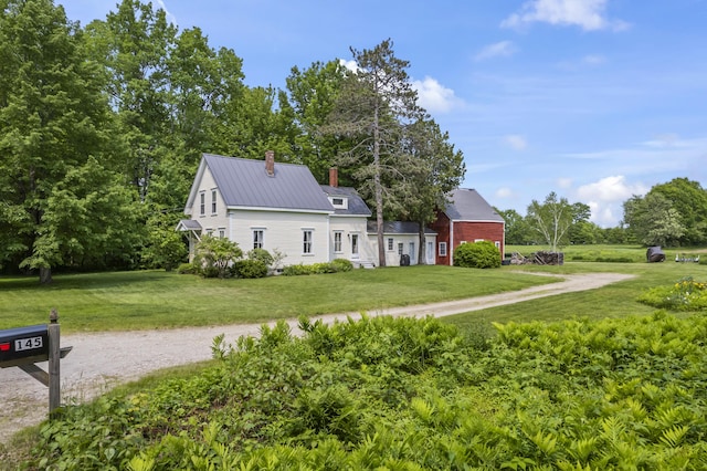 145 Pork Point Rd, Bowdoinham, ME 04008 - view of side of property with a chimney, a lawn, and metal roof
