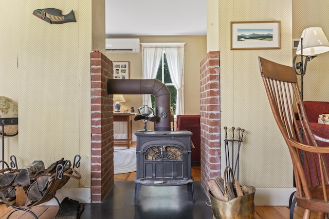 145 Pork Point Rd, Bowdoinham, ME 04008 - detailed view of a wall mounted AC, wood finished floors, and a wood stove