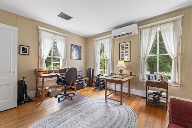 145 Pork Point Rd, Bowdoinham, ME 04008 - office space featuring an AC wall unit, wood-type flooring, and baseboards