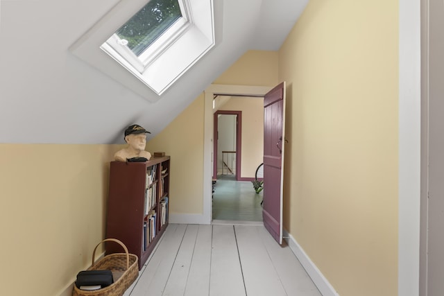 145 Pork Point Rd, Bowdoinham, ME 04008 - hallway with vaulted ceiling, a skylight, and baseboards