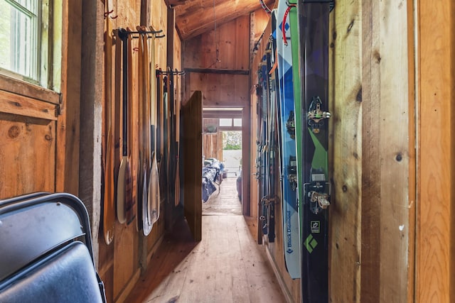 145 Pork Point Rd, Bowdoinham, ME 04008 - hallway featuring vaulted ceiling, light wood-style floors, and wooden walls