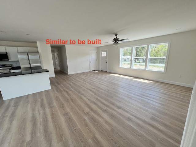 278 Merrill Rd, Levant, ME 04456 - unfurnished living room featuring light wood finished floors and ceiling fan
