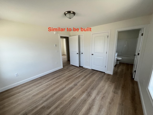 278 Merrill Rd, Levant, ME 04456 - unfurnished bedroom with wood finished floors and ensuite bathroom