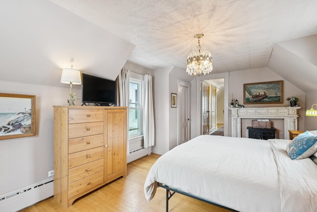 47 Beal St, Norway, ME 04268 - bedroom featuring a baseboard heating unit, light wood finished floors, a chandelier, and vaulted ceiling