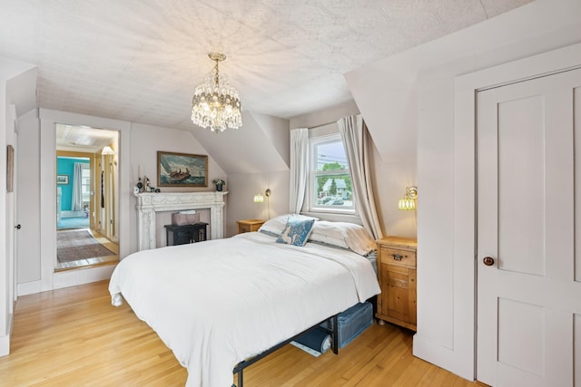 47 Beal St, Norway, ME 04268 - bedroom with light wood finished floors, a chandelier, and vaulted ceiling