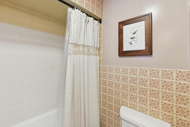 47 Beal St, Norway, ME 04268 - bathroom featuring toilet, shower / bath combination with curtain, wainscoting, and tile walls