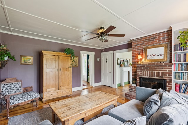 47 Beal St, Norway, ME 04268 - living area featuring hardwood / wood-style flooring, a fireplace, ceiling fan, crown molding, and baseboards