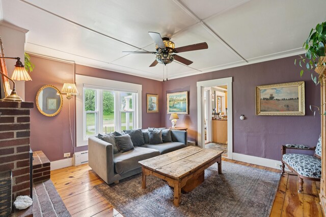 47 Beal St, Norway, ME 04268 - living area with baseboard heating, hardwood / wood-style flooring, ceiling fan, baseboards, and crown molding