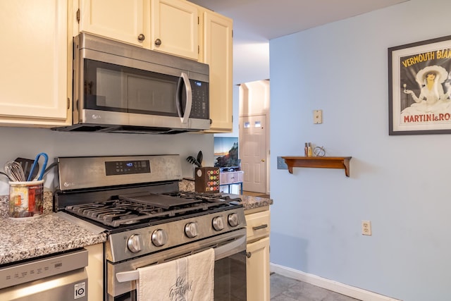 44 Cortland Cir Unit 44, Bangor, ME 04401 - kitchen with appliances with stainless steel finishes, light stone countertops, and light tile patterned flooring
