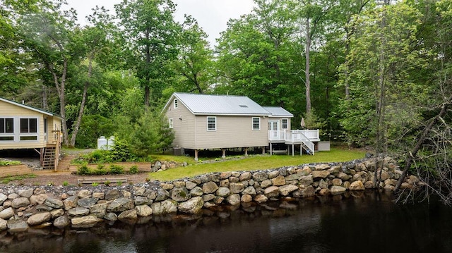 24 Dragon Back Rd, Naples, ME 04055 - rear view of property with stairs, a deck with water view, and a yard