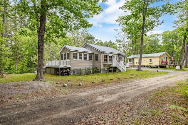 24 Dragon Back Rd, Naples, ME 04055 - view of front of property featuring a deck and a metal roof
