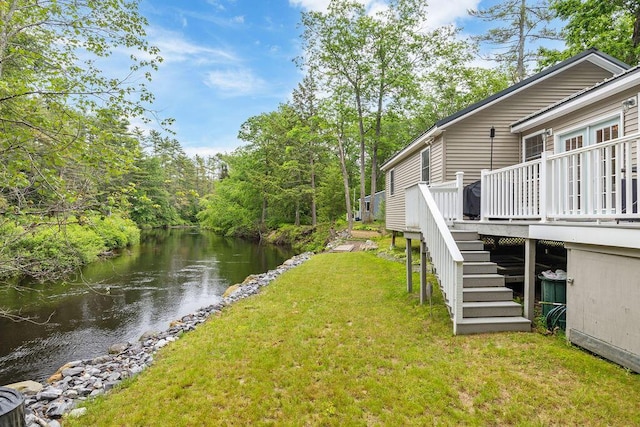 24 Dragon Back Rd, Naples, ME 04055 - view of grassy yard featuring stairway and a deck with water view